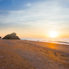 Fototapeta na wymiar sandy sea beach at the sunset, summer sea vacation scene