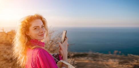 Close up portrait of curly redhead young caucasian woman with freckles looking at camera and...