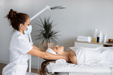 Masseur massaging chest of woman in spa salon
