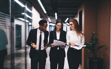Multiracial colleagues with papers having discussion