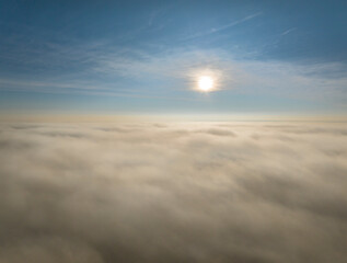 Fototapeta na wymiar sun rising over a dense layer of fog covering northern Colorado, aerial view