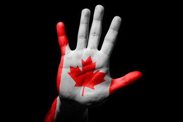 man hand with flag of Canada in stop sign