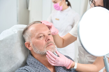 Man on a consultation with a beautician in medical center