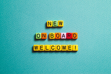 New on board welcome - word concept on cubes