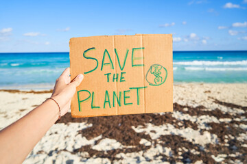 SAVE THE PLANET sign with sergeant in the background in the caribbean. - obrazy, fototapety, plakaty