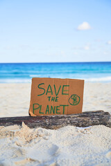 SAVE THE PLANET sign with the sea in the background. Ocean conservation.