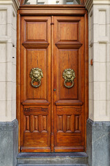 Old vintage door. Antique wooden door background with lock and handle on architecture facade home. 