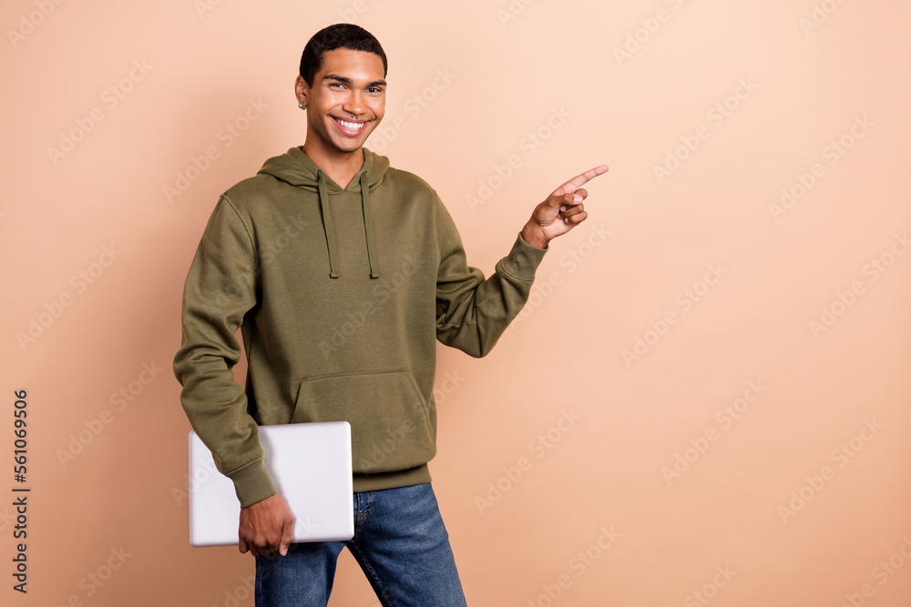 Poster Photo of young successful entrepreneur influencer businessman finger point empty space recommend laptop new ad isolated on beige color background