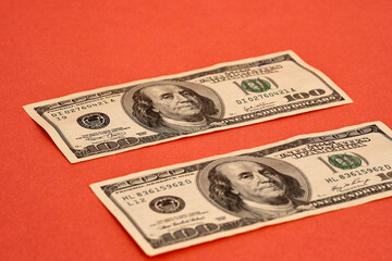 united states dollar bills isolated on red background.