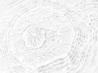 Fototapeta na wymiar Defocus blurred transparent white colored clear calm water surface texture with splashes and bubbles. Trendy abstract nature background. Water waves in sunlight with copy space. White water shine
