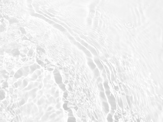 Defocus blurred transparent white colored clear calm water surface texture with splashes and bubbles. Trendy abstract nature background. Water waves in sunlight with copy space. White water shine