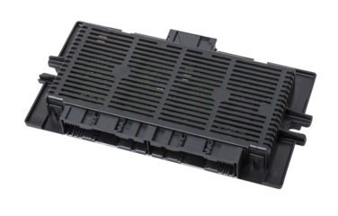 Plastic car engine control unit with plastic elements on a white isolated background is connecting center of various subsystems, units and assemblies. Monitoring the state of the moment. Spare part.