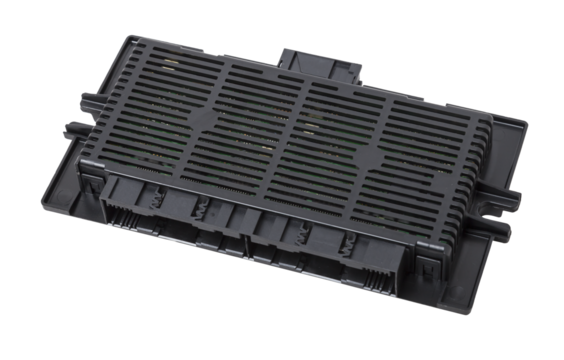 Plastic car engine control unit with plastic elements on a white isolated background is connecting center of various subsystems, units and assemblies. Monitoring the state of the moment. Spare part.