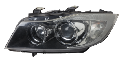 Stylish xenon left headlight of a German car - optical equipment with a lamp inside on a white isolated background. Spare part for auto repair in a car workshop.
