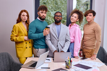 Successful Confident Business Men And Women Gathered Together In Office, Posing At Camera, Diverse...