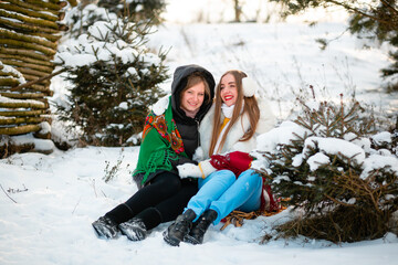 Fototapeta na wymiar Vinnytsia, Ukraine. January 10, 2022: Two Ukrainian sisters are walking in the park in winter, smiling and wearing warm, beautiful clothes. Professional teeth cleaning