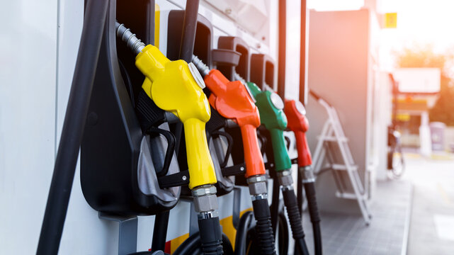 Petrol pump filling fuel nozzle in gas station. Fuel Pump, Gas Station, Gasoline. Colorful Petrol pump filling nozzles 