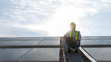 Engineer working setup Solar panel at the roof top. Engineer or worker work on solar panels or solar cells on the roof of business building