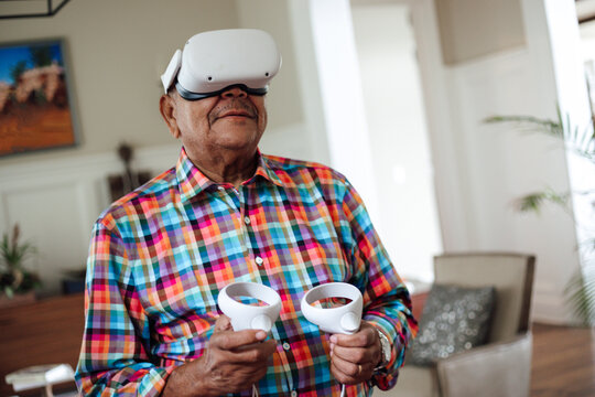 Senior man enjoying a virtual reality game