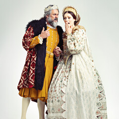 King, queen and surprised in medieval costume for royal party, retro carnival and theatre fashion clothes in white background. Couple, shocked face and vintage renaissance standing isolated in studio