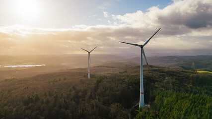 high angle view of wind turbines in the forest in sunlight