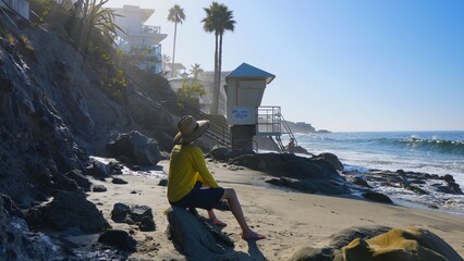 Man sitting at Laguna Beach, CA