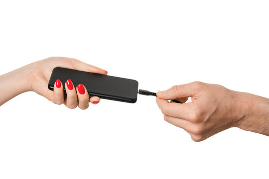 Smartphone in a woman's hand, Type C charging cable in a man's hand on a white background, isolate.