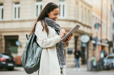 Fototapeta premium Marketing woman, travel digital writing and tablet blog of journalist working on street for city story. Social media, happy and young urban reporter outdoor from Spain email about creative job vision