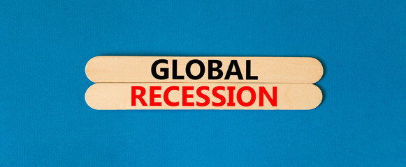 Global recession symbol. Concept words Global recession on wooden stick. Beautiful blue table blue background. Business and global recession concept. Copy space.