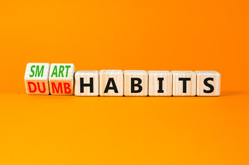 Smart or dumb habits symbol. Concept word Smart habits and Dumb habits on wooden cubes. Beautiful orange table orange background. Business smart or dumb habits concept. Copy space.