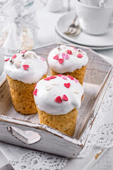 Traditional Neapolitan baba au rum with sugar fondant served as close-up on a white shabby chic wooden tray