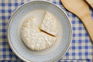 Camembert cheese on a bowl on table 