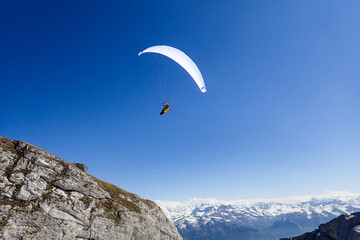 Fototapeta na wymiar Paragliding in flight over the top