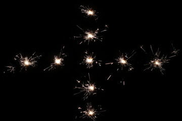 Burning sparklers on a black background