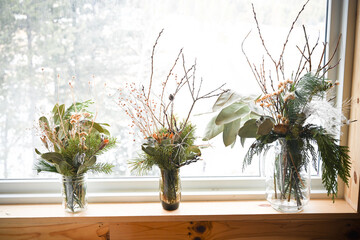 Flower arrangements on a white background in boulder colorado on a white sheet in front of a window...