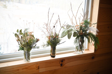 Flower arrangements on a white background in boulder colorado on a white sheet in front of a window - natural and sustainable arrangements