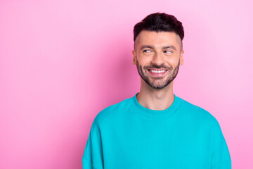 Portrait of smiling positive guy brunet hair looking empty space satisfied result barber shop salon isolated on pastel pink color background