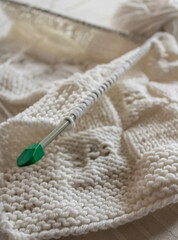 White knitting wool texture closeup, a ball of white wool and knitting needles background