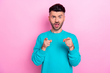 Photo of impressed young man questioned funny grimace open mouth point fingers camera you isolated on pink color background