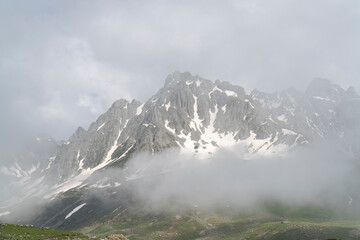 Snow-capped mountains in the fog. Panoramic view of peaks mountain 