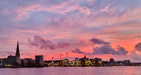Skyline of the city of rostock during sunset, beautiful cloudy sky with colors 