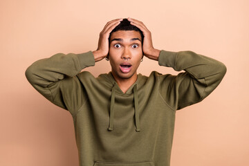 Photo of young hipster nervous guy touch hands head stressed panic forgot turn off electricity problems scared isolated on beige color background