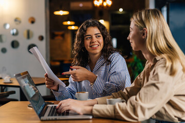 Two businesswoman are discussing work