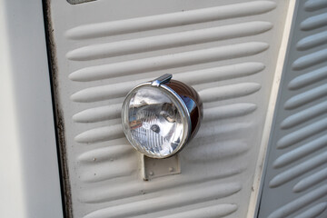 Headlight of an old Citroen H-type corrugated iron panel van