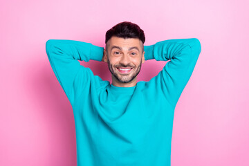 Photo of young positive wearing blue sweatshirt man chilling take nap pause break after hard work days hands head isolated on pink color background