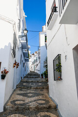 Fototapeta na wymiar Empty narrow street in a traditional spanish village of Frigiliana
