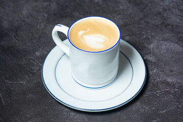 Hot Cappuccino served in coffee cup isolated on grey background top view of indian and bangladesh food