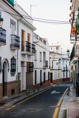 Fototapeta na wymiar Empty narrow street and typical spanish buildings in Nerja, Spain