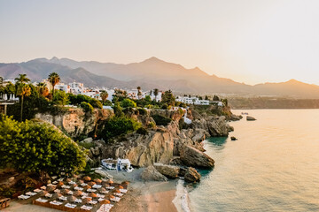 Fototapeta premium El Chorrillo beach in Nerja, view from Balcon de Europa in a golden morning light