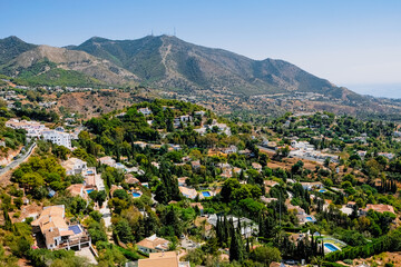 Fototapeta na wymiar Mediterranean landscape, mountain backdrop, houses with pools near Malaga, Andalusia, Spain